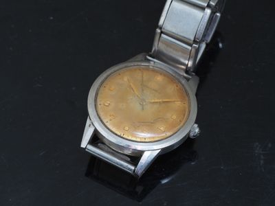 a watch that is sitting on a black surface