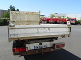 a truck that is parked in a lot with other trucks