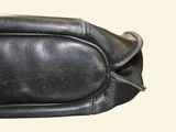 a black purse that is sitting on a table