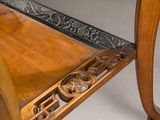 a close up of a wooden bench with a decorative design