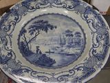 a blue and white plate with a picture of a boat on it