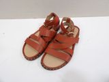 a close up of a pair of red sandals on a white surface