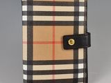 burberl checkered wallet with a black leather strap