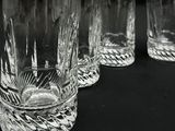 four glasses that are lined up on a table