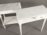 two white tables with marble tops on a gray background