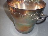 a silver cup that is sitting on a table