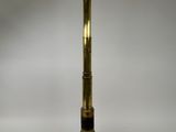 an antique brass telescope on a white surface with a white background
