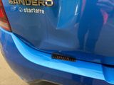 a close up of a blue car with a sticker on it