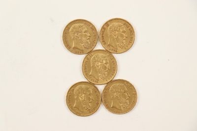 four gold coins are arranged in a pyramid on a white surface