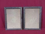 two framed pictures of a couple of letters on a red cloth