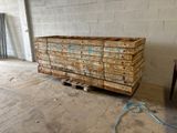 a pallet of wood sitting on a pallet in the middle of a room