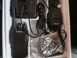 a box with two walkie talkies and a charger