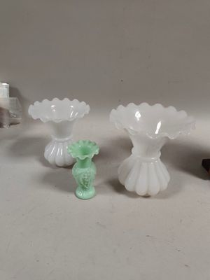 three vases sitting on a table next to each other