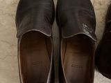 pair of men ' s shoes sitting on a tile floor next to a box of shoes