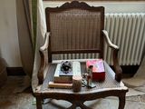a chair that has a book on it in front of a window