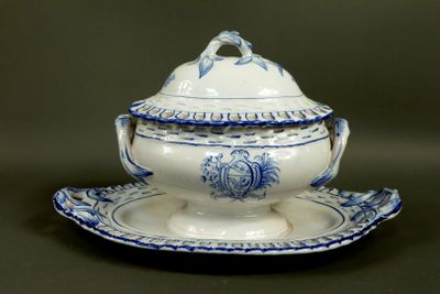 a blue and white tureeny with a lid on a plate