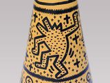 a vase with a design on it sitting on a table