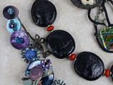 a lot of jewelry that is laying out on the table