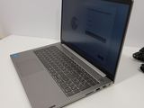 laptop on a white table with a mouse and a mouse pad