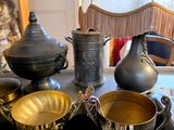 a table that has a lot of silver and gold items on it