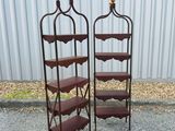 pair of vintage iron and wood shelves with scallops on them