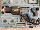 a corded drill in a plastic case on the floor