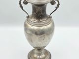 an antique silver vase with handles on a white background