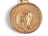 gold medal with the image of the virgin of guadalupe on it