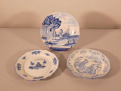 three blue and white plates and a bowl sitting on a table