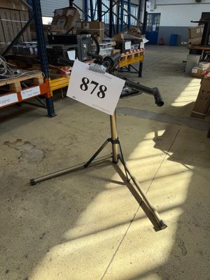 a sign on a tripod in a large warehouse