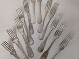 a lot of forks arranged in the shape of a tree