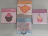 three boxes of cupcakes and a cookie cutter on a table