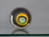 a close up of a bottle of wine on a glass table