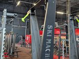 a gym with a lot of machines in the room
