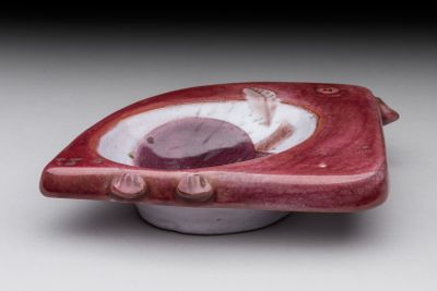 a red and white bowl with a fish inside of it