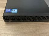 a close up of a black laptop on a wooden table