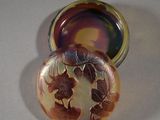 a picture of a small glass container with a flower design on it