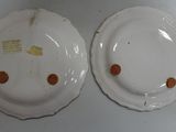 pair of white porcelain plates with brown spots on them