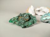 three pieces of green and white rocks on a white surface