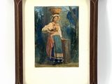 une vieille photo d'une femme tenant un bébé dans un cadre en bois