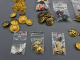 a lot of gold buttons and other items on a table