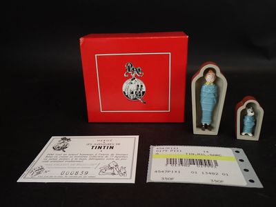 une boîte contenant une petite figurine représentant une femme en robe bleue