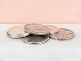 a close up of a pile of coins sitting on top of a table