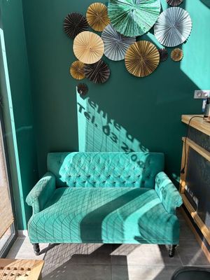 a couch and a chair in a room with green walls