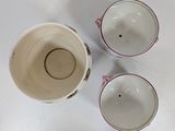 three cups that are sitting on a table