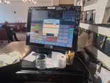 a desk with a computer monitor and many papers on it