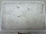 a white tray with a handle on a white table