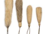 four different types of fur brushes on a white background