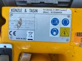 a close up of a yellow machine with a sticker on it
