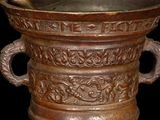 a large metal bowl with a wooden spoon in it